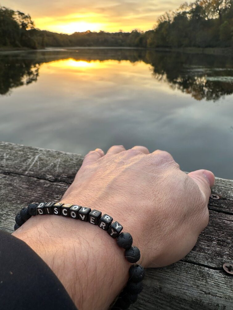 hand on wooden bridge at sunrise